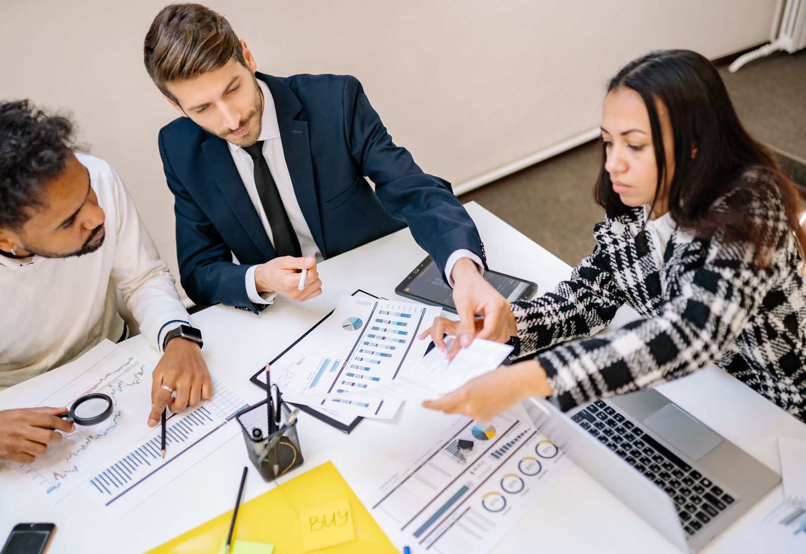 Colleagues reviewing documents and charts in a meeting