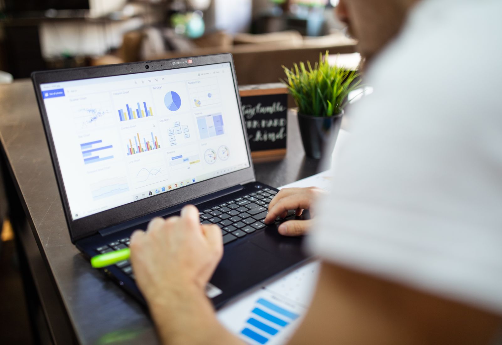 Business analysis with charts and graphs displayed on a laptop