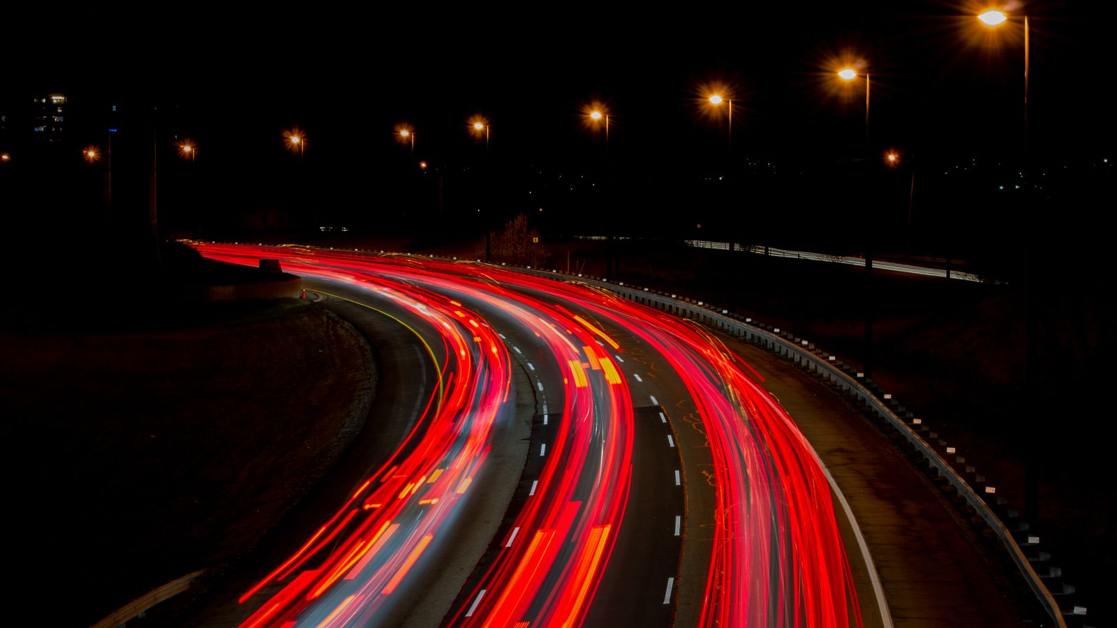 Long exposure photograph of light trails on a road at night